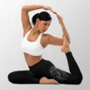 Woman performing a yoga pose in black leggings with line drawing of a lions head