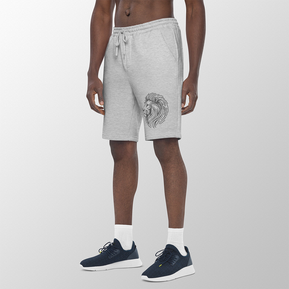 Man wearing black fleece shorts with line drawing of a lion head on the left leg